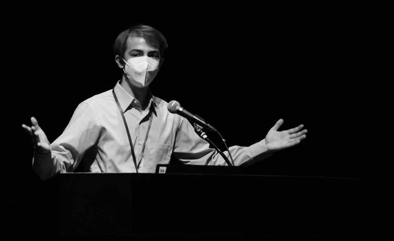Robin speaking at a lectern