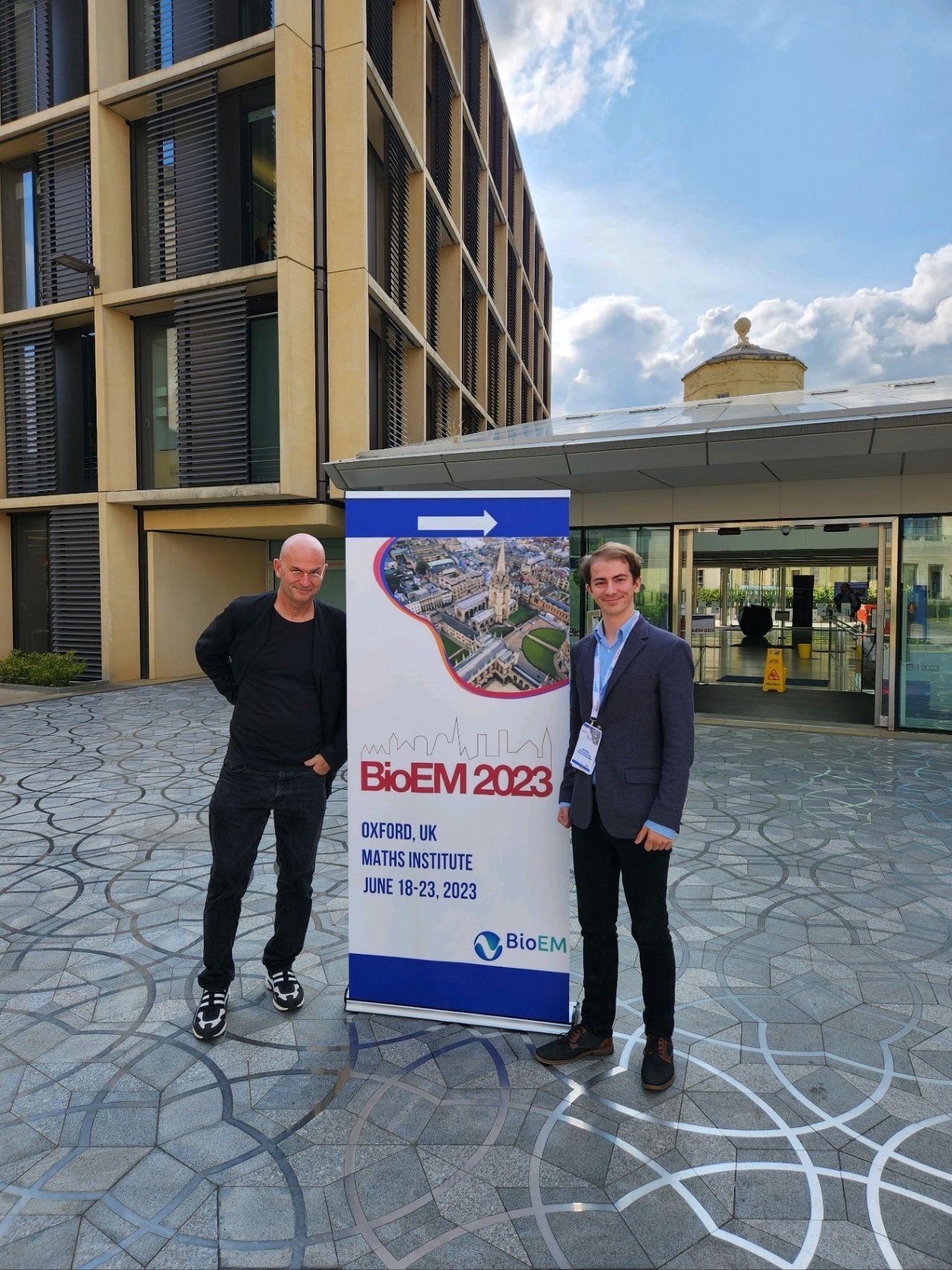 Robin beside the BioEM 2023 banner